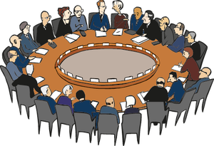 Viele Menschen sitzen an einem Tisch unf unterhalten sich auf einer Konferenz