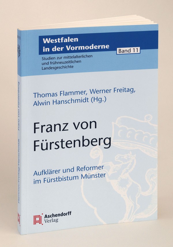 Auf der bläulichen Vorderseite des Buches ist das Wappen von Westfalen in weiß zu sehen